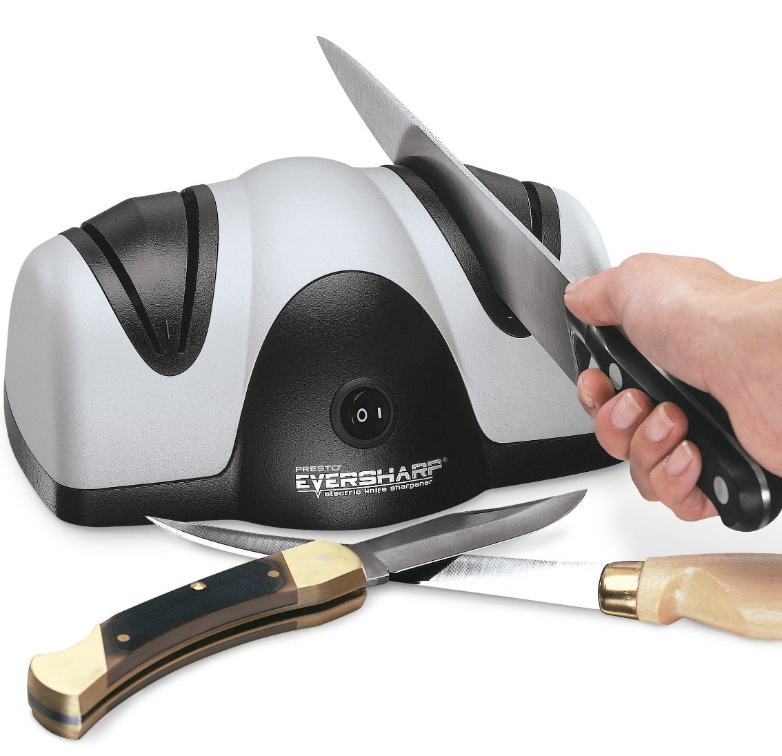 The black and silver machine says &quot;PRESTO EVERSHARP ELECTRIC KNIFE SHARPENER&quot; and has three knifes around it