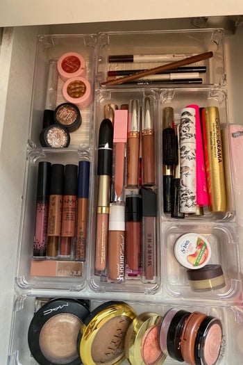 reviewer's makeup drawer with clear bins organizing it