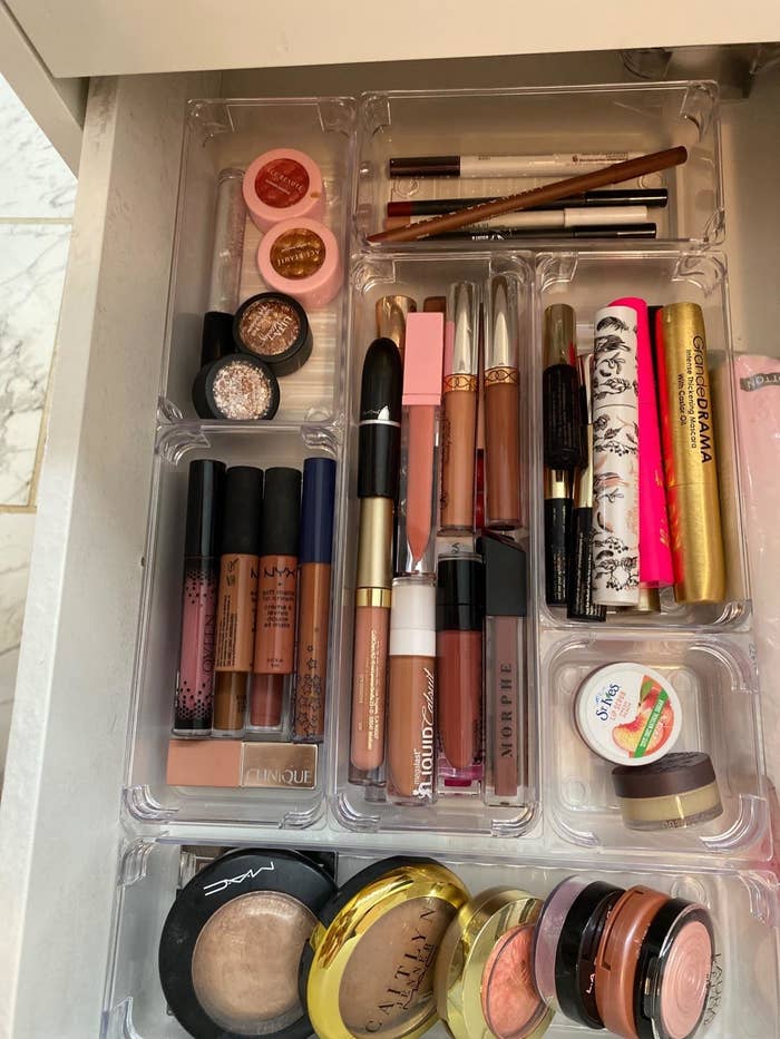 reviewer showing a makeup drawer with clear bins organizing it