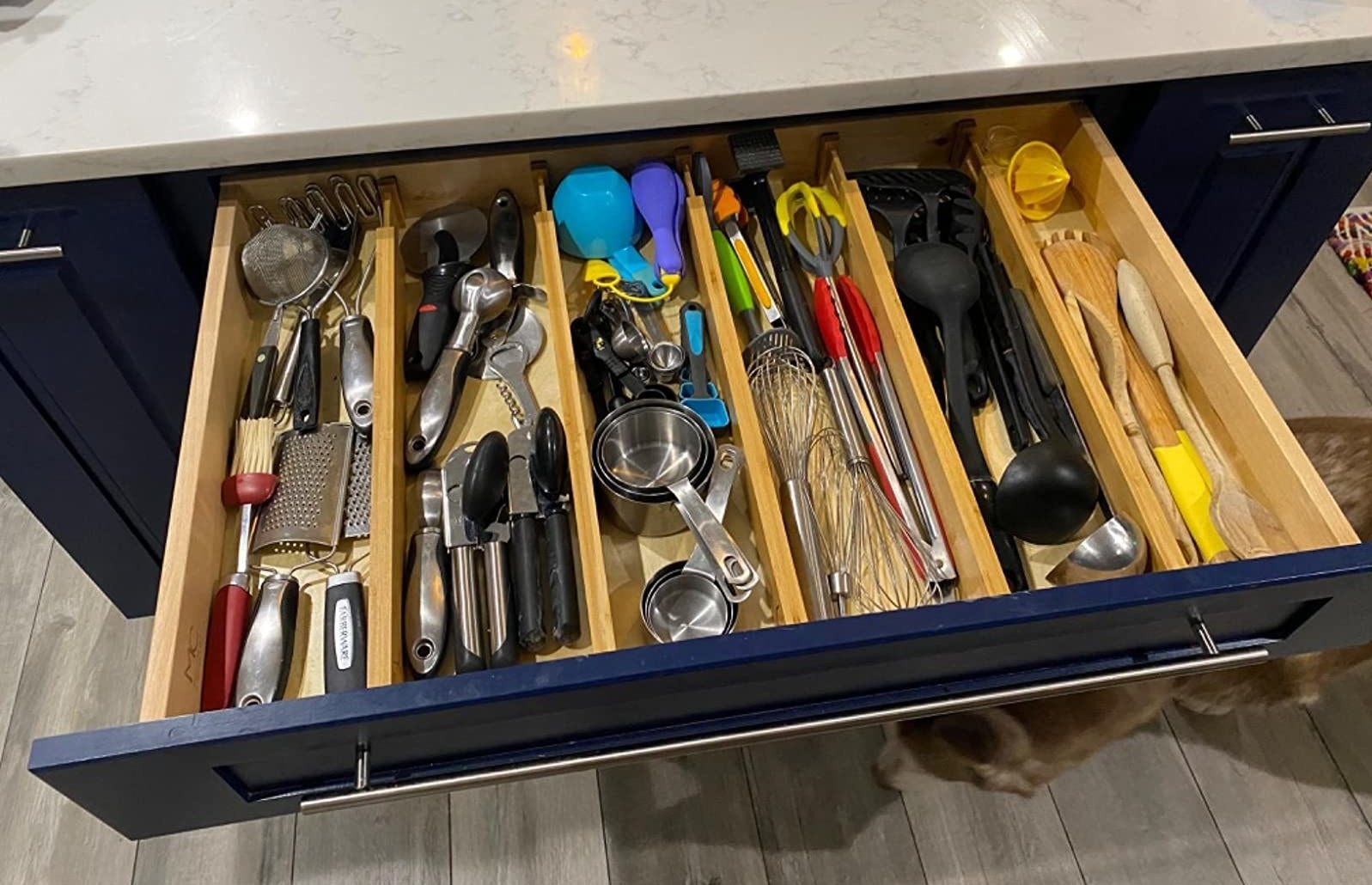 reviewer photo of a big kitchen drawer with five bamboo drawer dividers organizing it