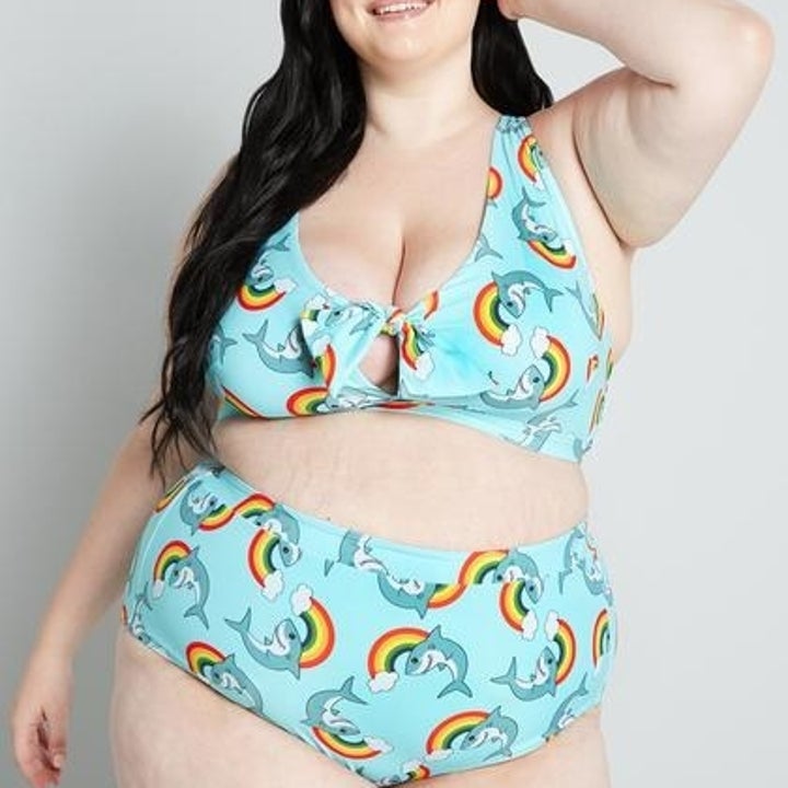model wearing turquoise bikini set with rainbows and sharks