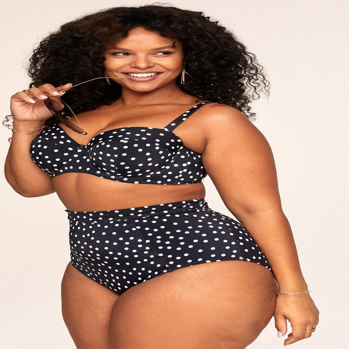 model wearing black and white polka dot bikini set with high waist