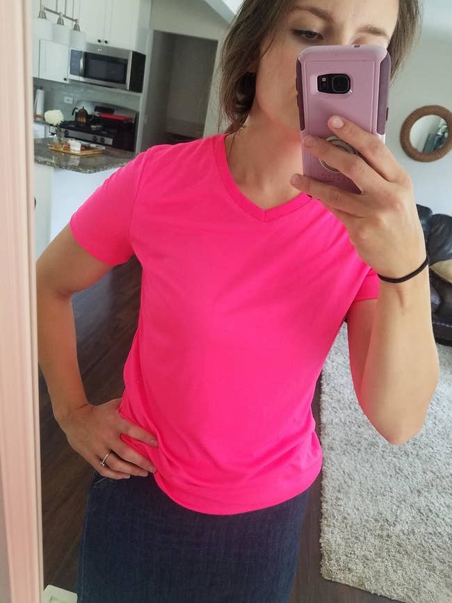 Reviewer wearing pink V-neck Hanes tee