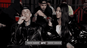 Travis Barker and Kourtney Kardashian eat lollipops together