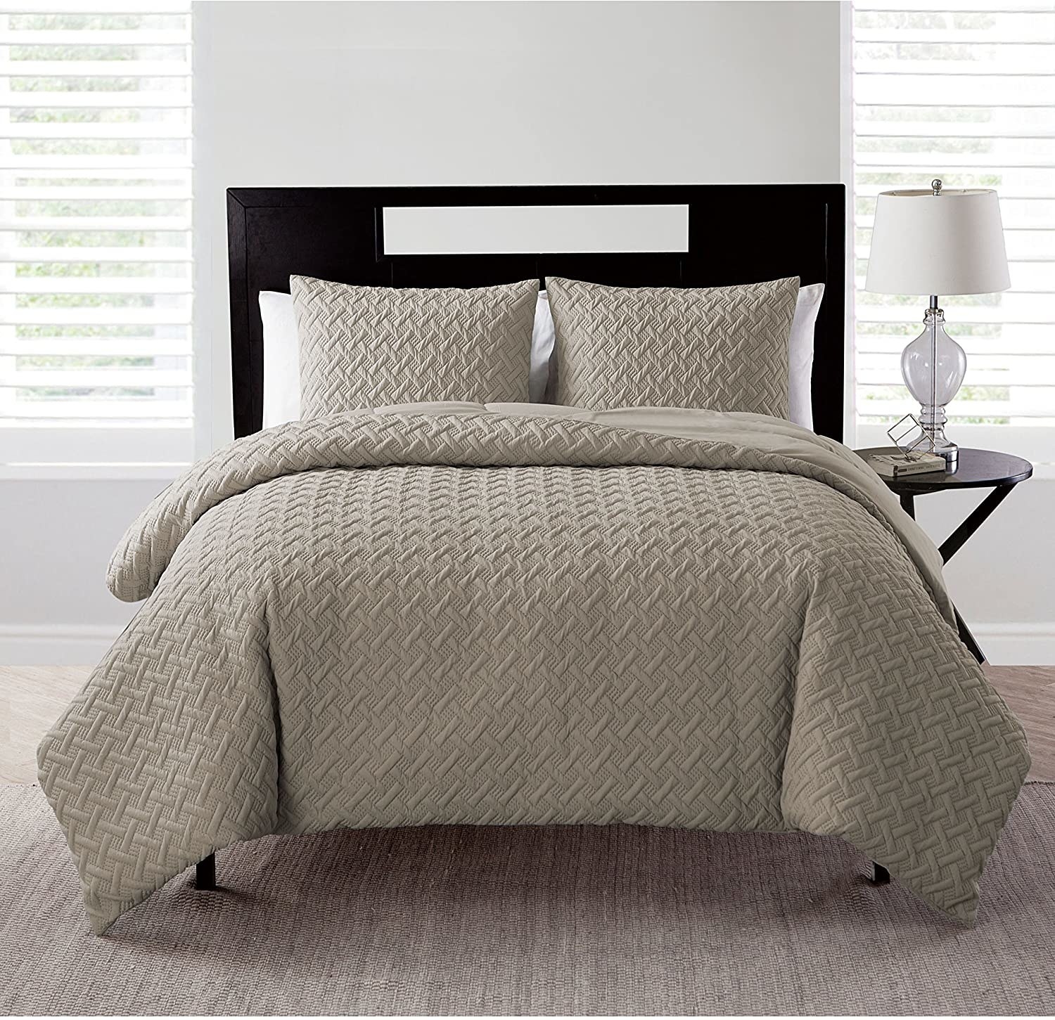The VCNY Home Nina Collection bedding set on a made bed in taupe