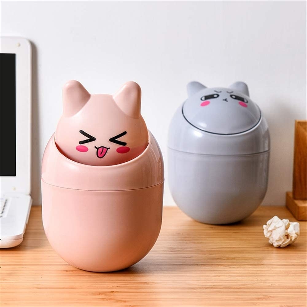 Two pill-shaped mini trash cans with animal faces 