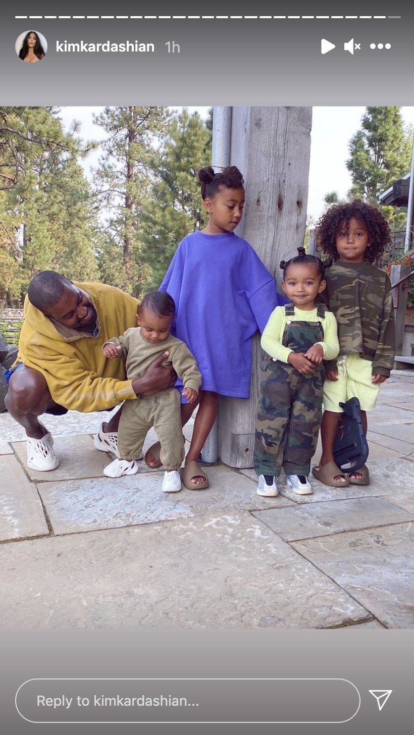 Kanye poses with the couple&#x27;s children helping Psalm stand with his siblings