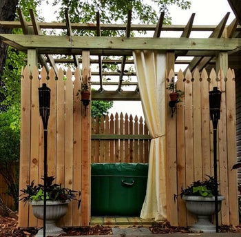 inflatable hot tub in wooden structure in reviewer's backyard