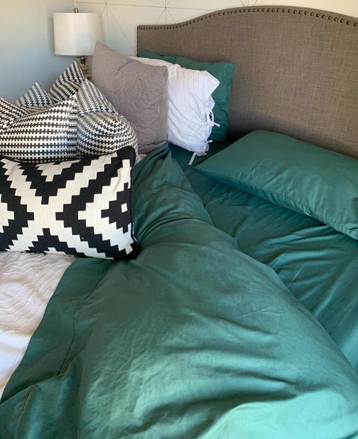 The sheet set in green on a reviewer&#x27;s bed