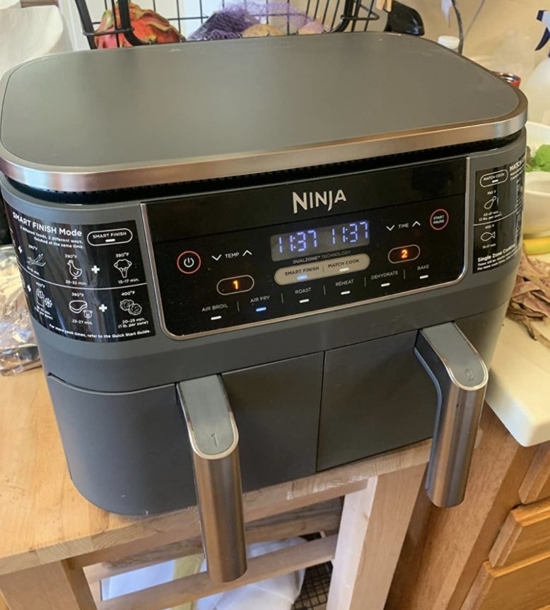 a reviewer showing the air fryer