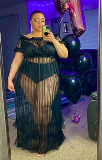 A customer review photo of them taking a mirror selfie in the dress
