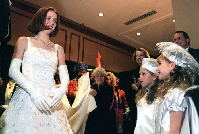 Elizabeth Claire Kemper, the 1999 Veiled Prophet Queen of Love and Beauty, speaks with pages Katy Angevine (left), 8, and Jacqueline Probst, 7, before going on stage Thursday night to accept her crown.