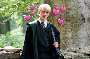 Draco brooding with hearts surrounding him