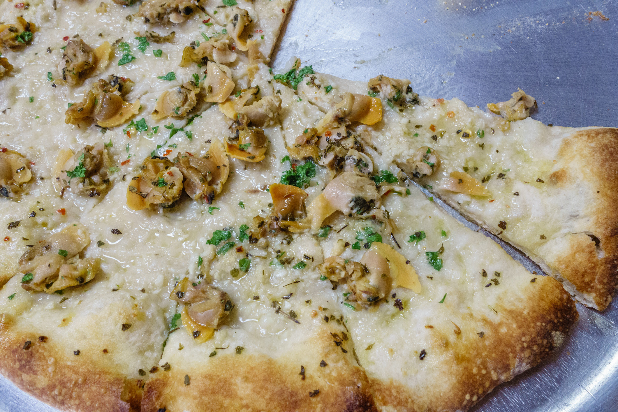 close-up of clam pizza on tray