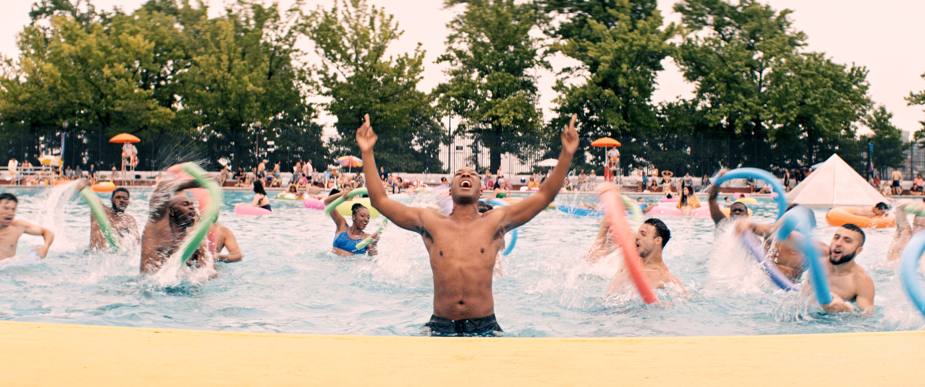 People dancing in the pool during the &quot;96,000&quot; musical number