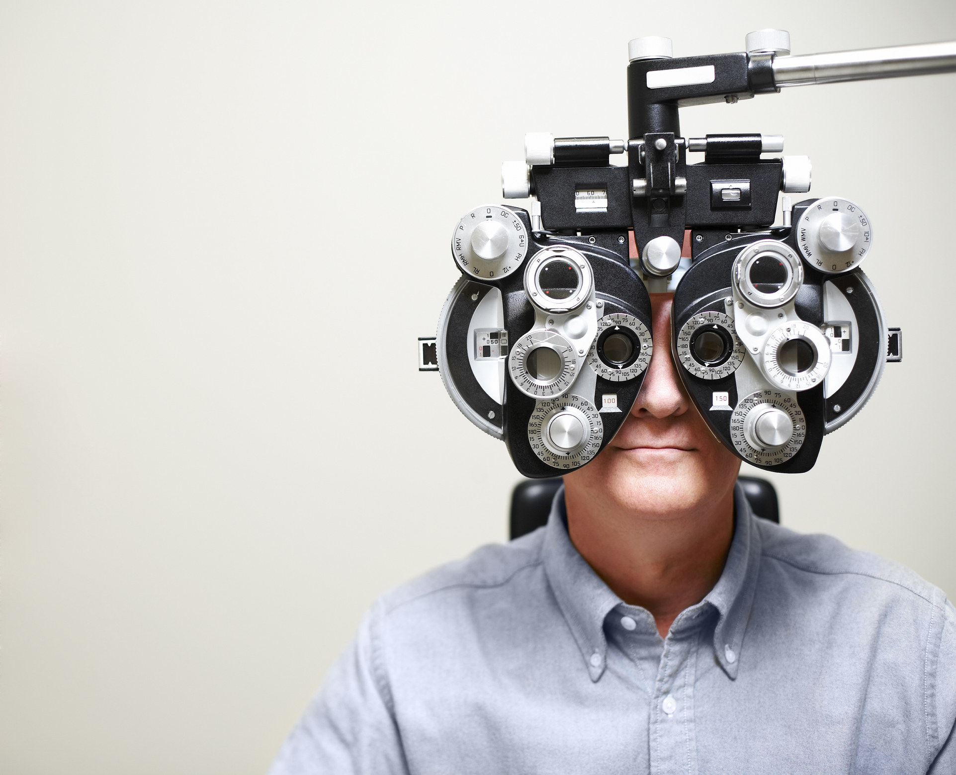 Guy looking into an eye-checking machine