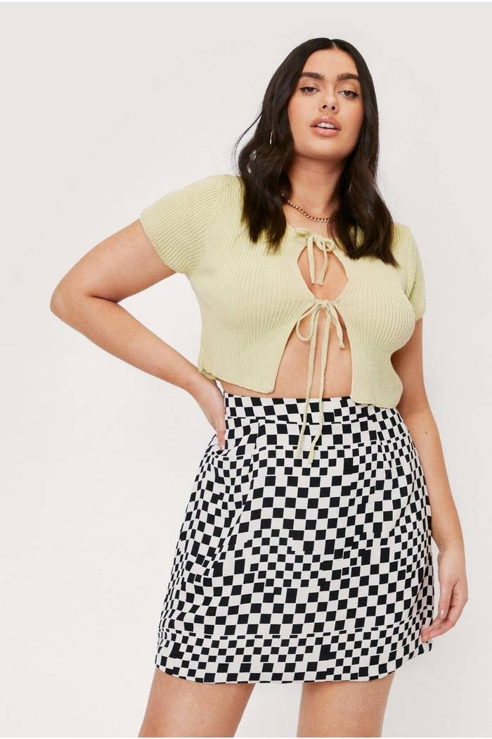 Model wearing checkerboard printed mini-skirt