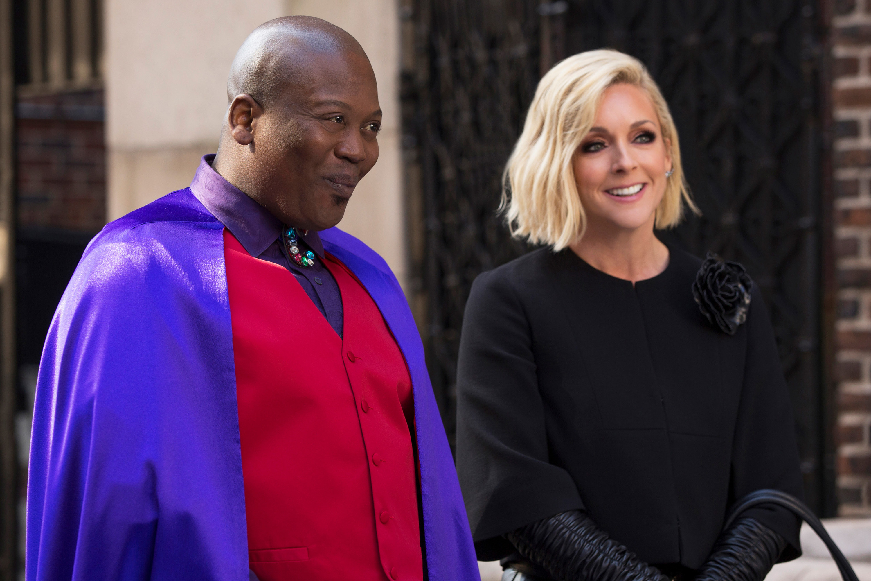 Tituss Burgess and Jane Krakowski smile on the street