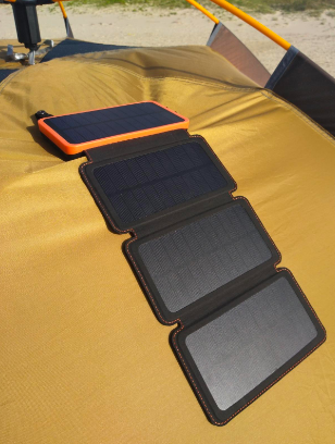 Four panel compact charger laying in the sun 