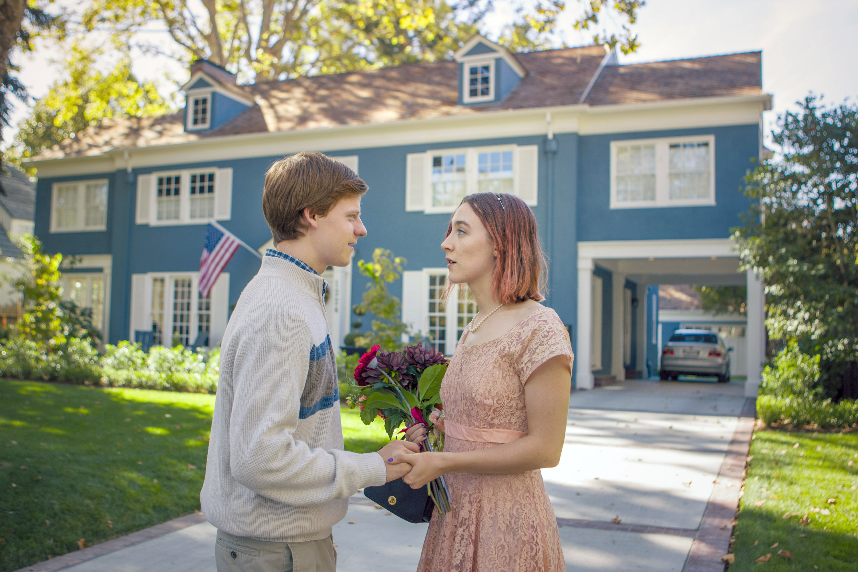 Lucas Hedges and Saoirse Ronan chat outside a gorgeous blue house