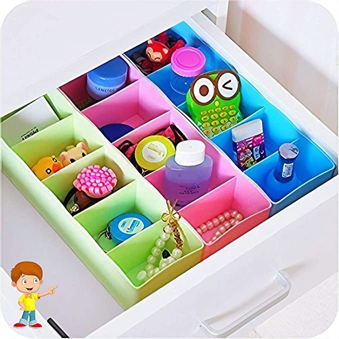 Drawer organisers with stationery in them.
