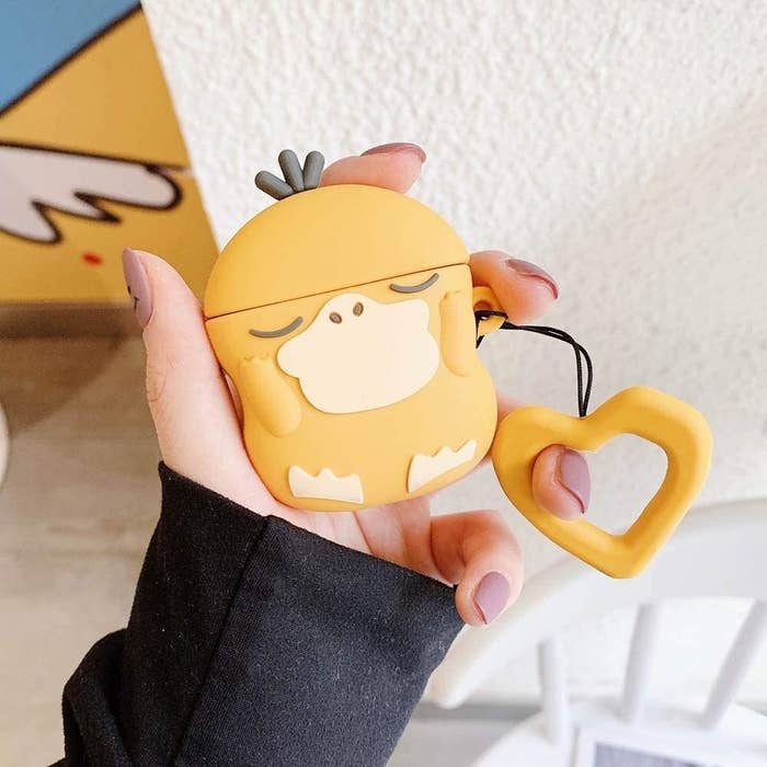 a person holding the psyduck airpods case