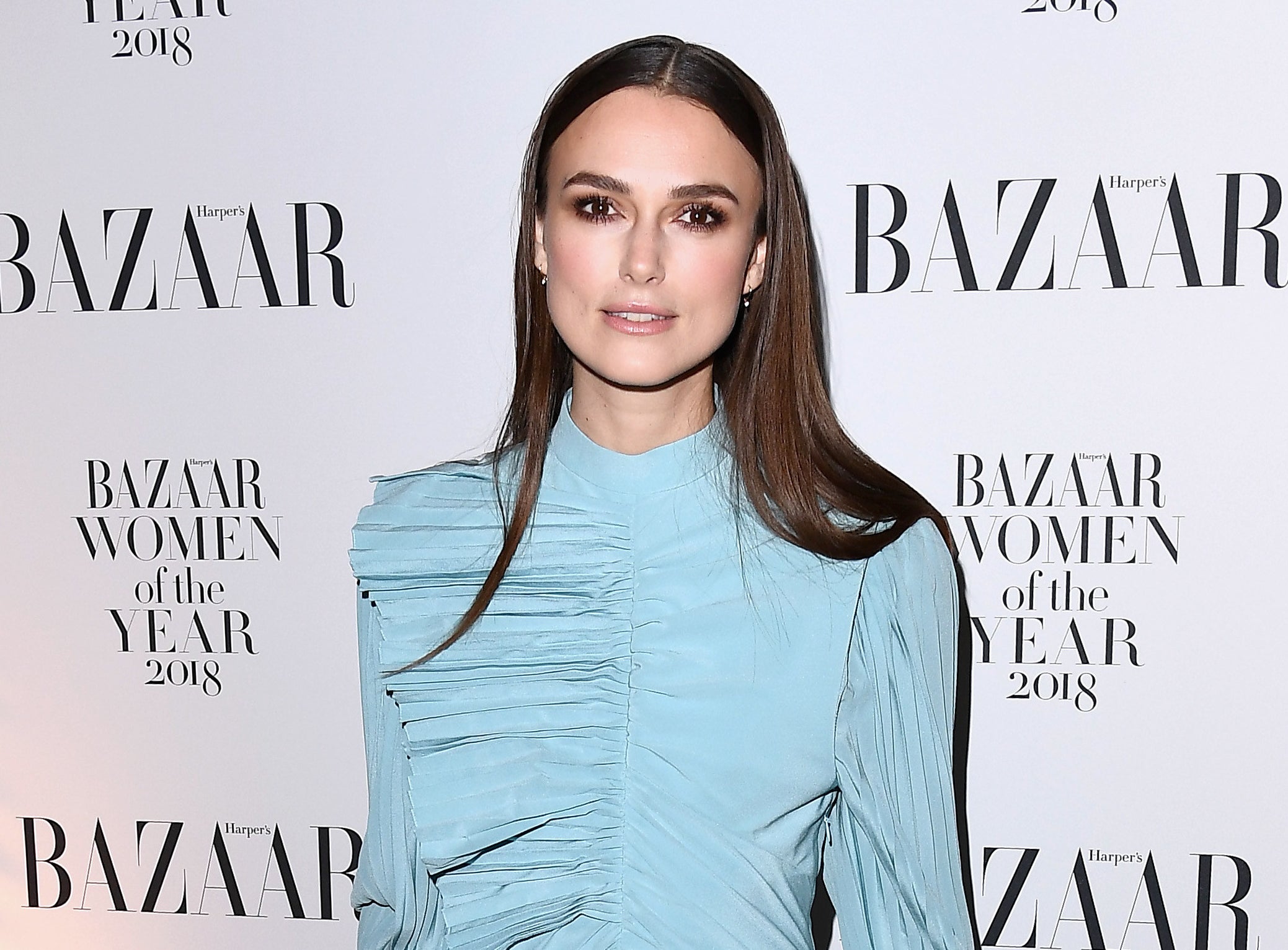 Keira wears a long sleeve blue dress