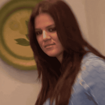 An annoyed looking Khloé Kardashian stares blankly