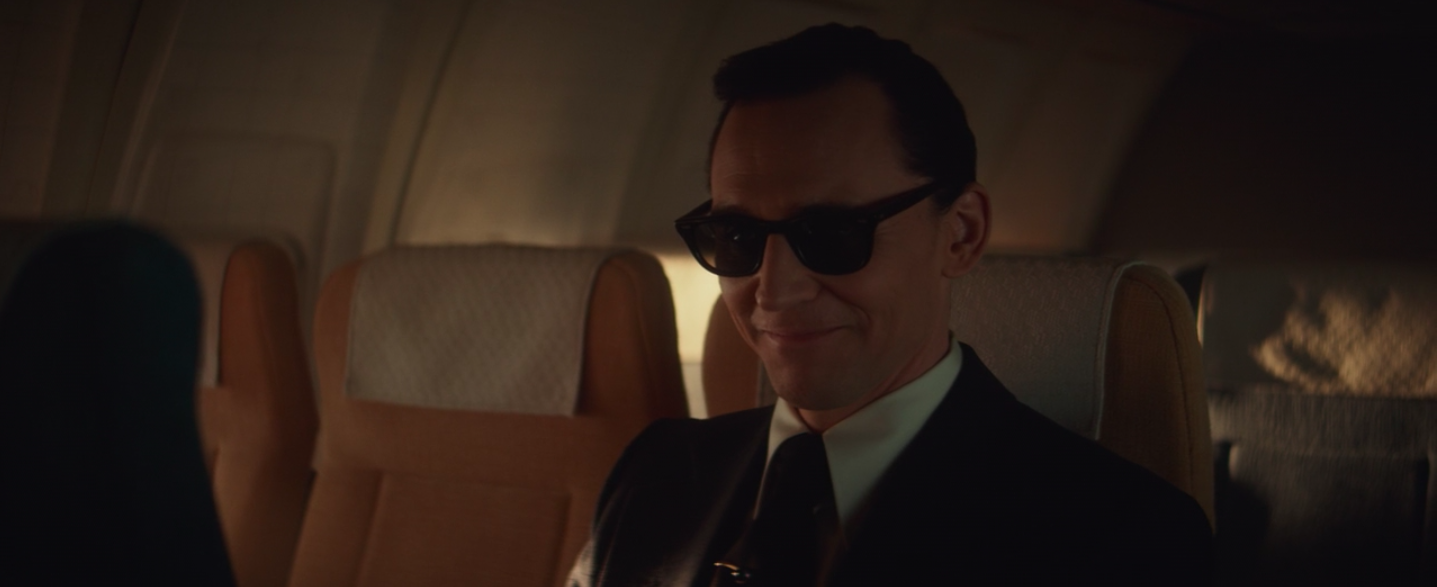 Loki smiling with sunglasses as &quot;D B Cooper&quot;