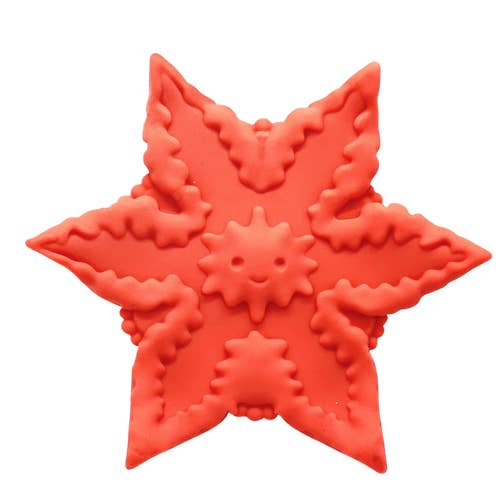 Orange star-shaped silicone vibrator with detailed ridges and a smiley in the middle