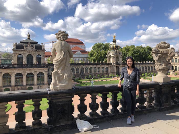 The author pictures in Dresden, leaning on the second floor of a baroque building.