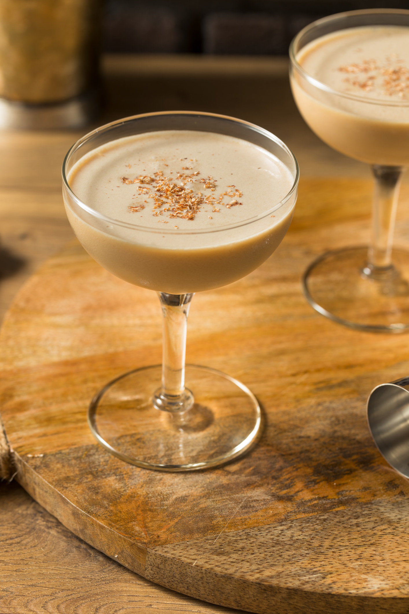 Two glasses of Brandy Alexander on a wooden table