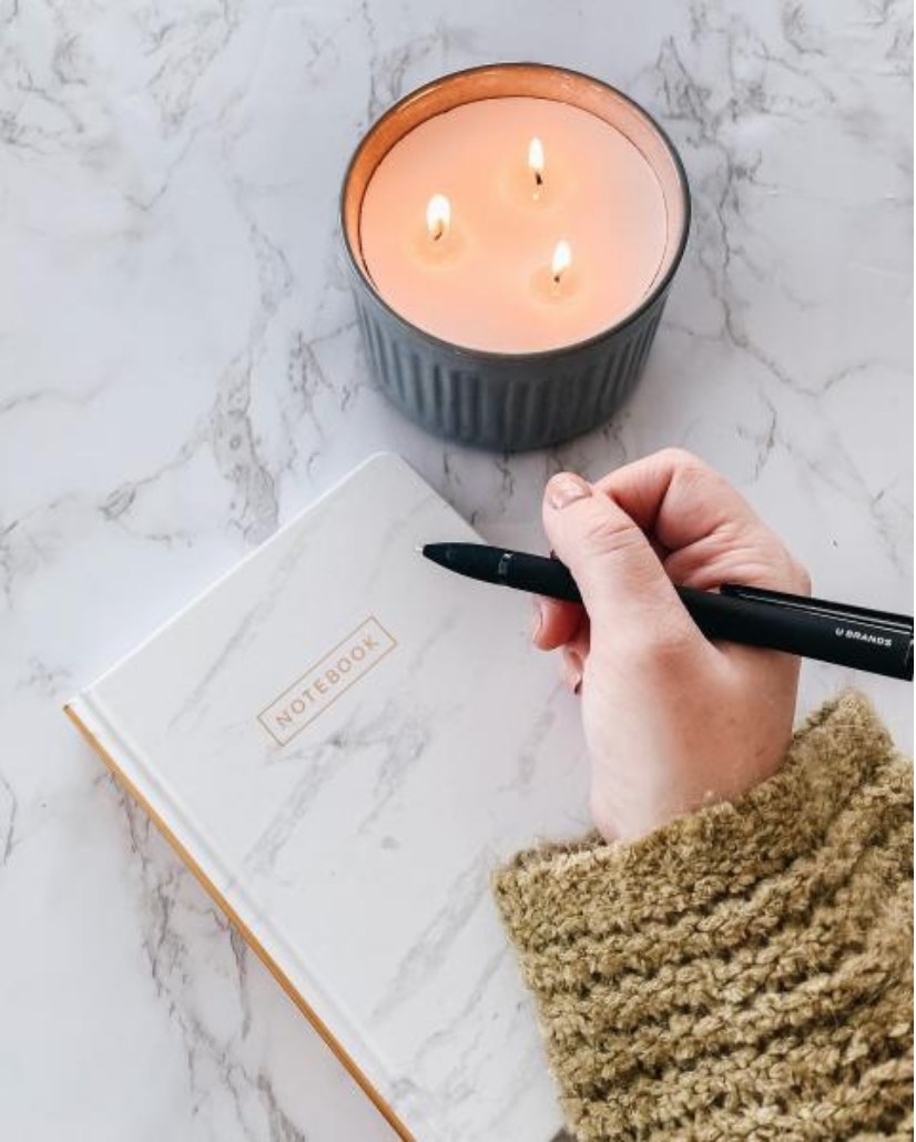 A model using a notebook with a marble and gold design