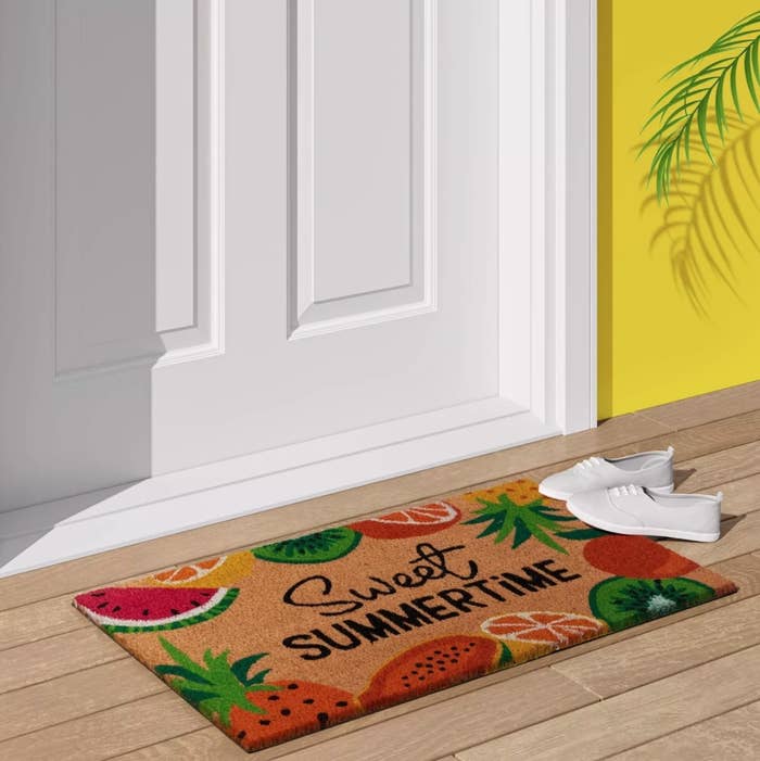 the floral doormat with the word &quot;sweet summertime&quot;