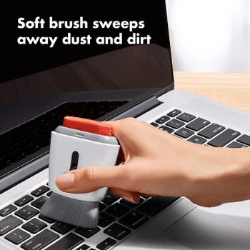 Model using brush to clean laptop keyboard