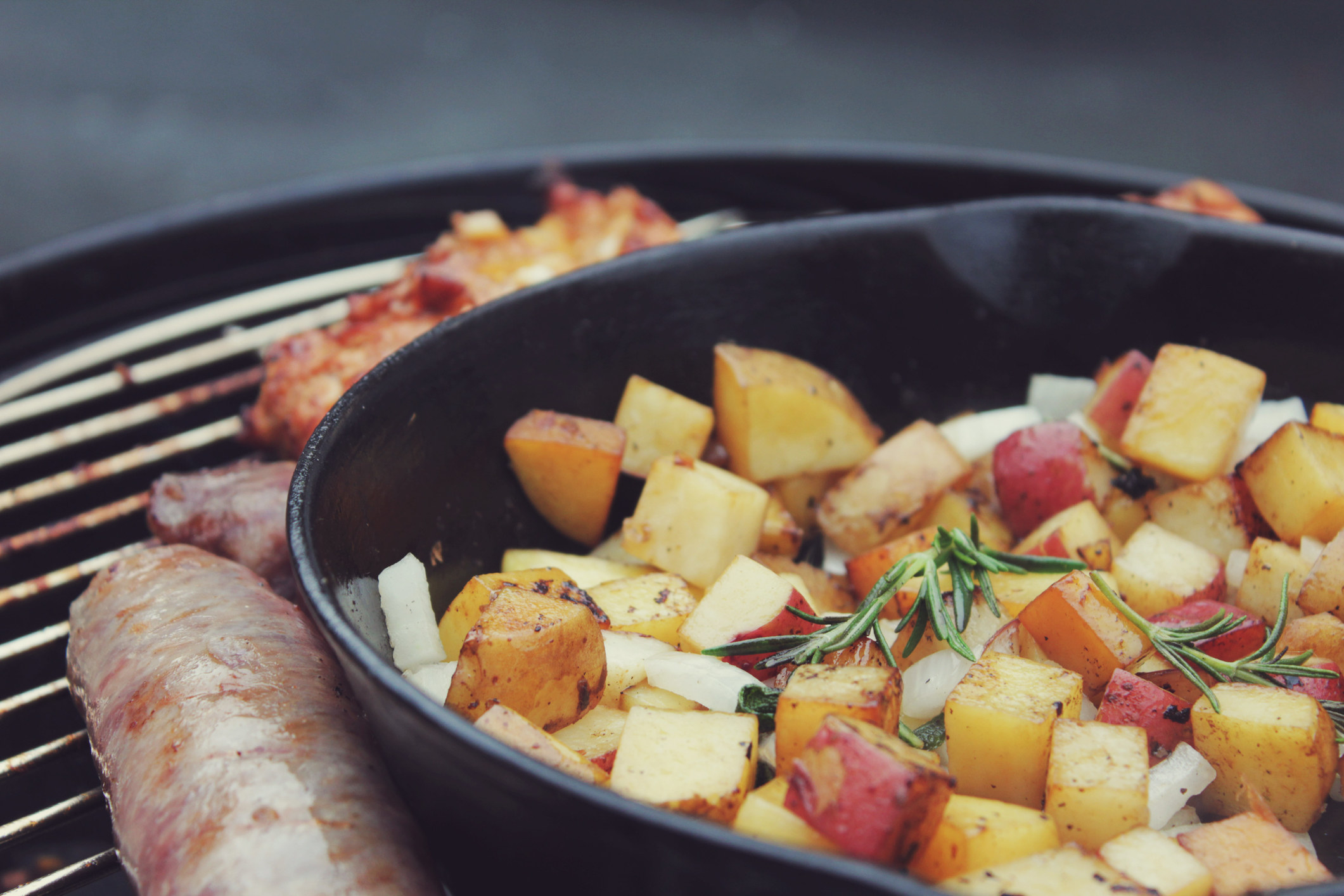 Grilling potatoes in a cast iron skillet.
