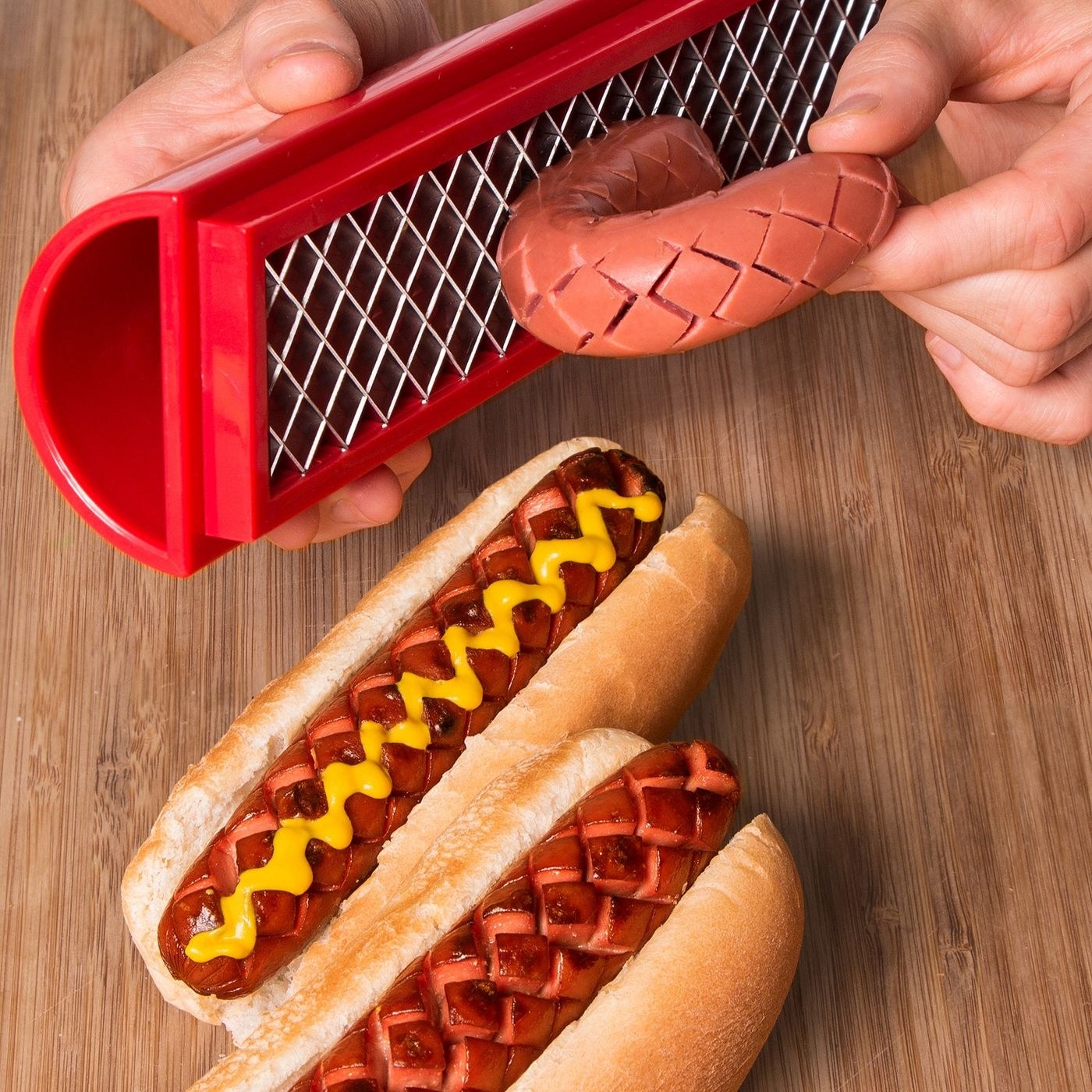 criss-crossed blade cutting into a hot dog