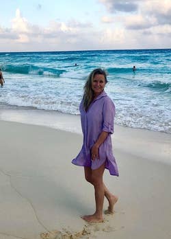 reviewer wearing a lilac cover-up while at the beach
