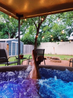 another reviewers feet sticking out of the hot tub
