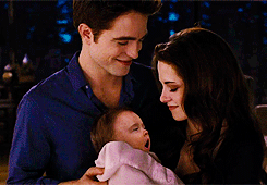Bella and Edward holding Renesmee