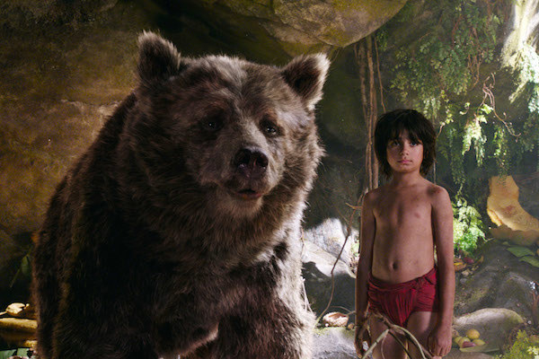 Baloo (voiced by Bill Murray) standing next to Neel Sethi