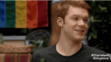 Ian Gallagher shyly ducks his head as he laughs before scratching the top of his head.