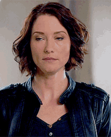 Alex Danvers rolls her eyes before looking to the side, lifting her eyebrows, and smiling slightly.