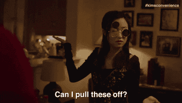 gif of janet from kim&#x27;s convenience wearing flip sunglasses saying &quot;can i pull these off?&quot;