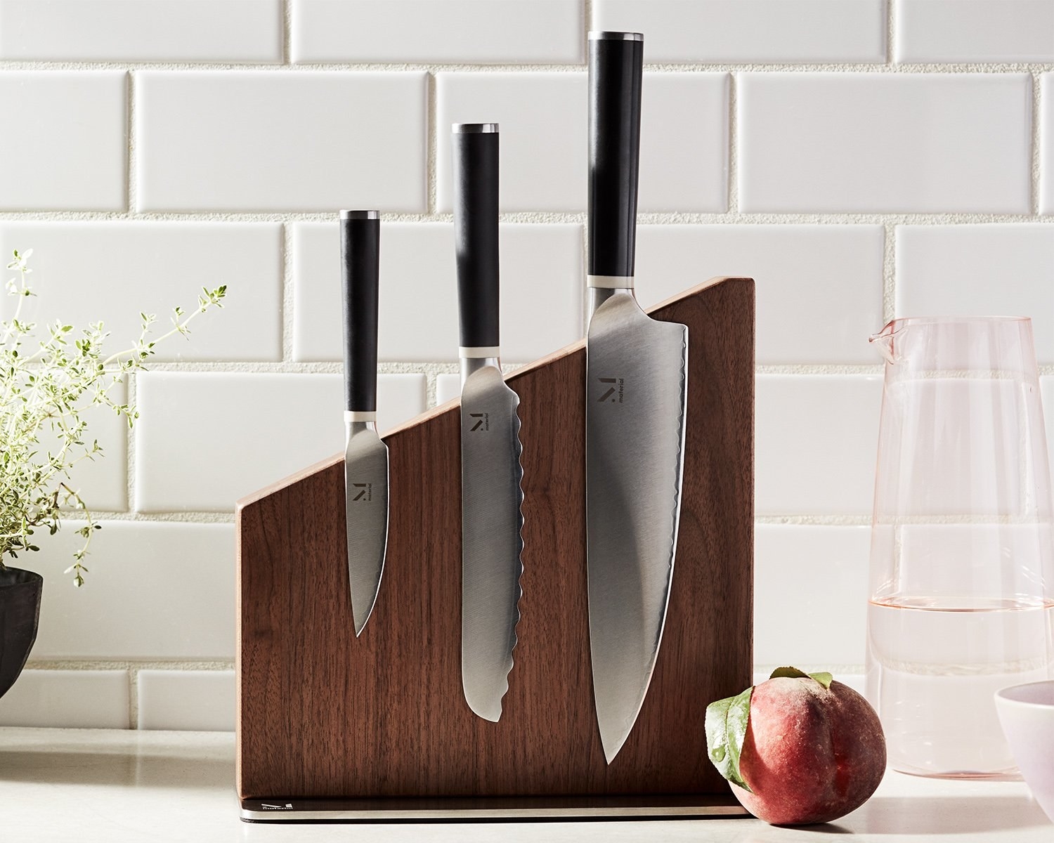 the wooden stand with three kitchen knives 