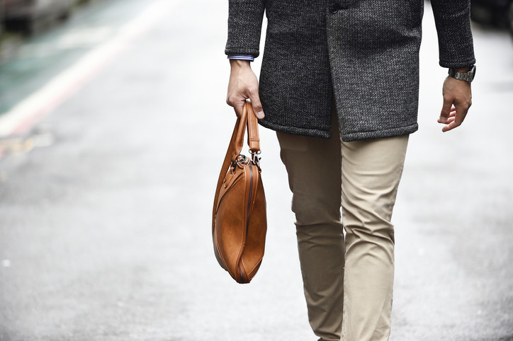 Man holding a leather bag