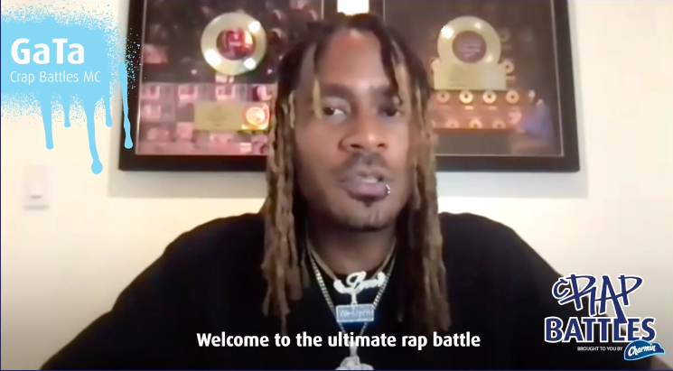 GaTa sitting on a video call. Subtitles say &quot;Welcome to the ultimate rap battle&quot;.