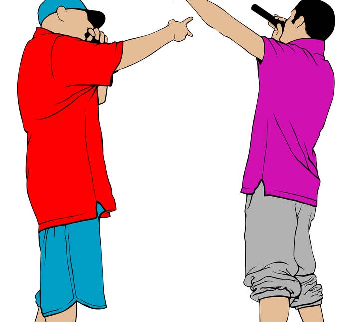 Two men with microphones in their hands rap battling