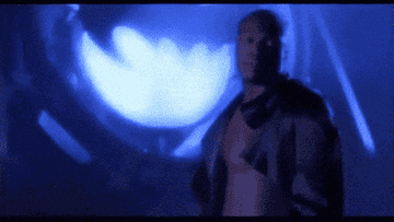 GIF of Seal singing in front of the Bat Sign in the music video for &quot;Kiss from a Rose&quot;