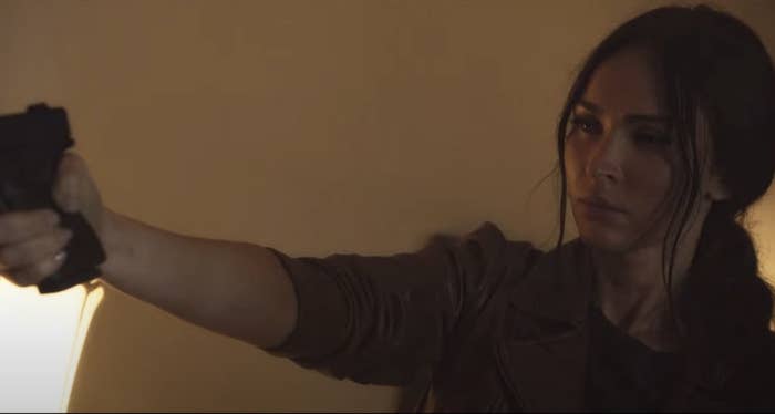 Megan holds up a gun in the film